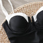 Black and white bikini top with thin straps on woven mat