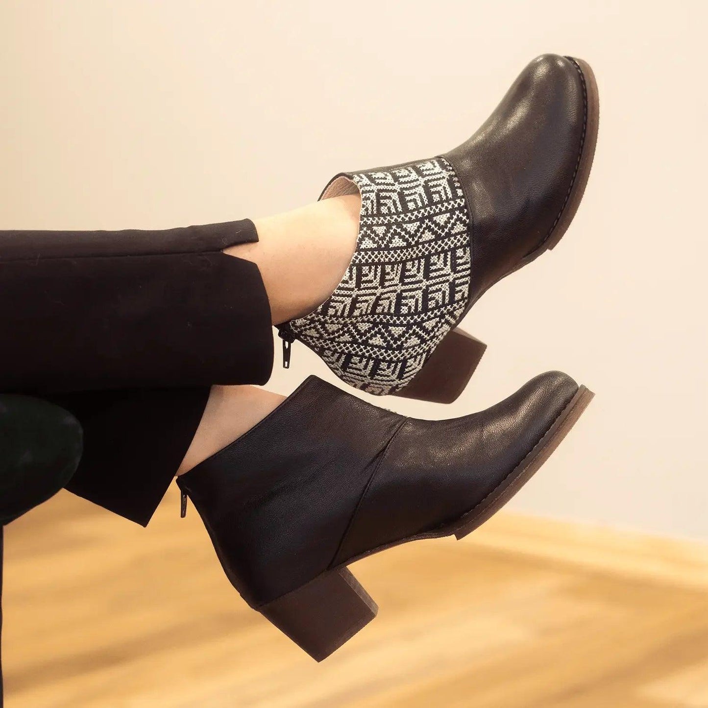 Black ankle boots with geometric knit panel, block heel, and side zipper for women's fashion