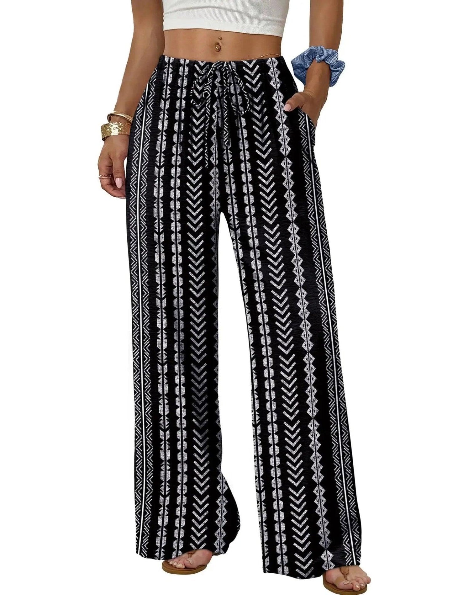 Women's black and white geometric print wide-leg palazzo pants with drawstring waist, perfect for casual fashion.