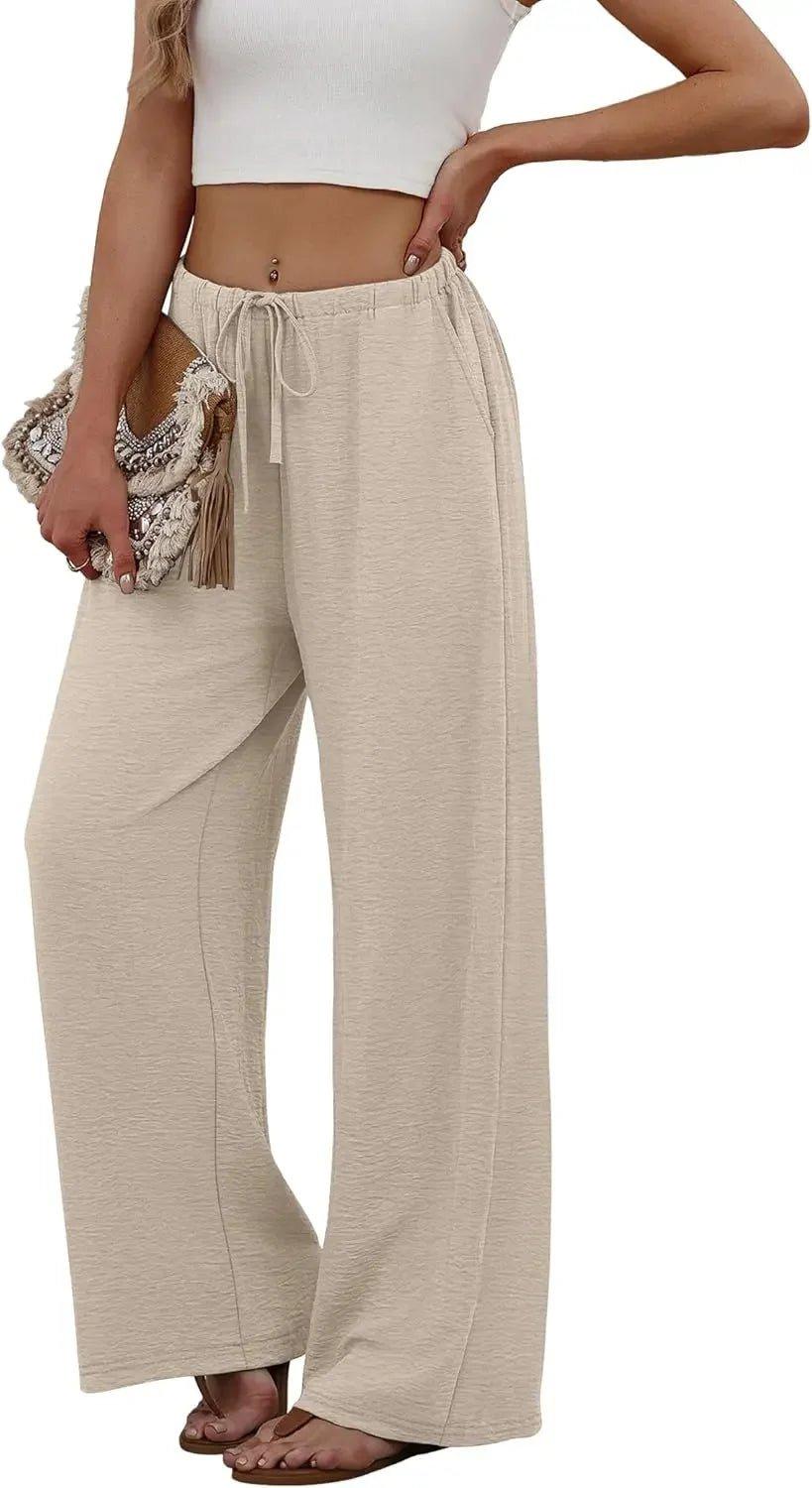 Beige wide-leg drawstring pants with white crop top and boho clutch, women's fashion