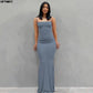 Woman in elegant gray maxi dress with spaghetti straps, perfect for fashion events and evening wear.