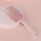 Pink detangling hairbrush with soft bristles for gentle styling and everyday hair care