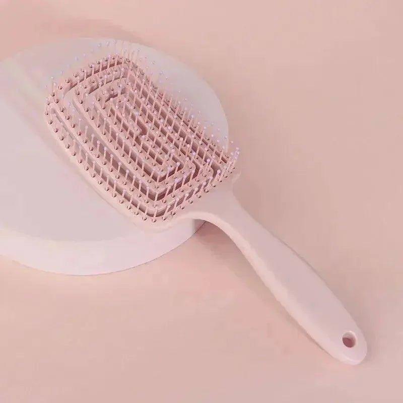 Pink detangling hairbrush with soft bristles for gentle styling and everyday hair care