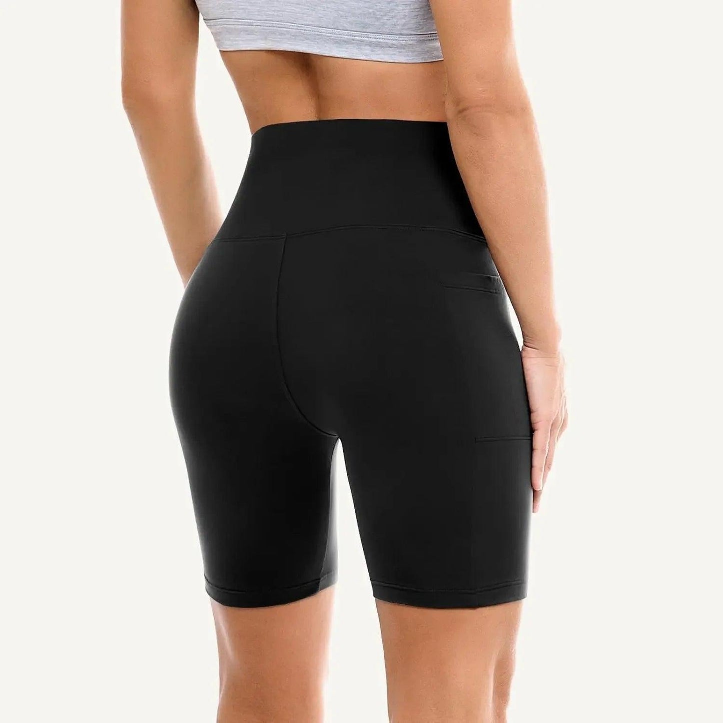 Black high-waisted biker shorts with pockets, women's fitness wear, gym activewear