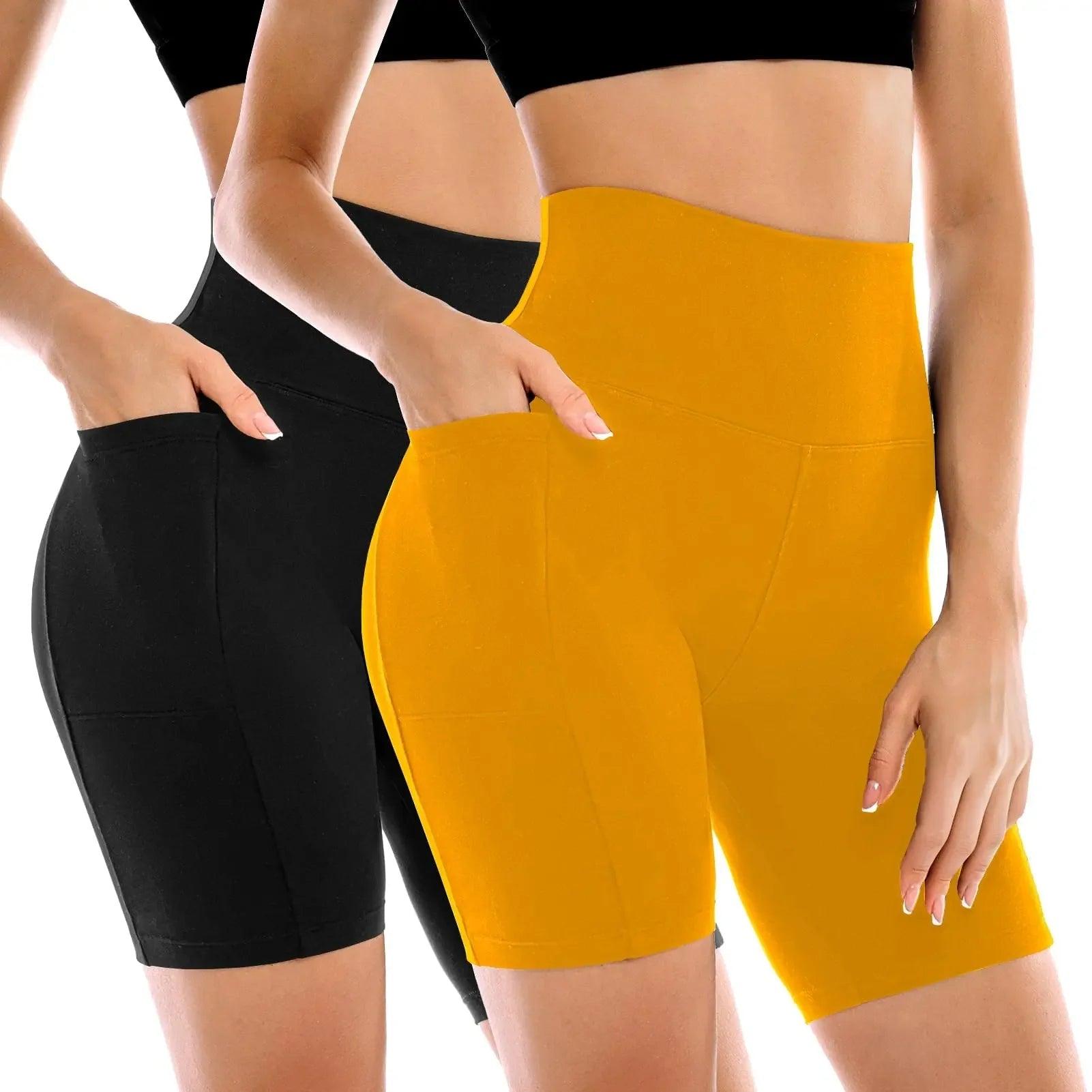 Women's high-waisted biker shorts in black and mustard yellow, featuring side pockets and stretchy fabric for fitness or casual wear.
