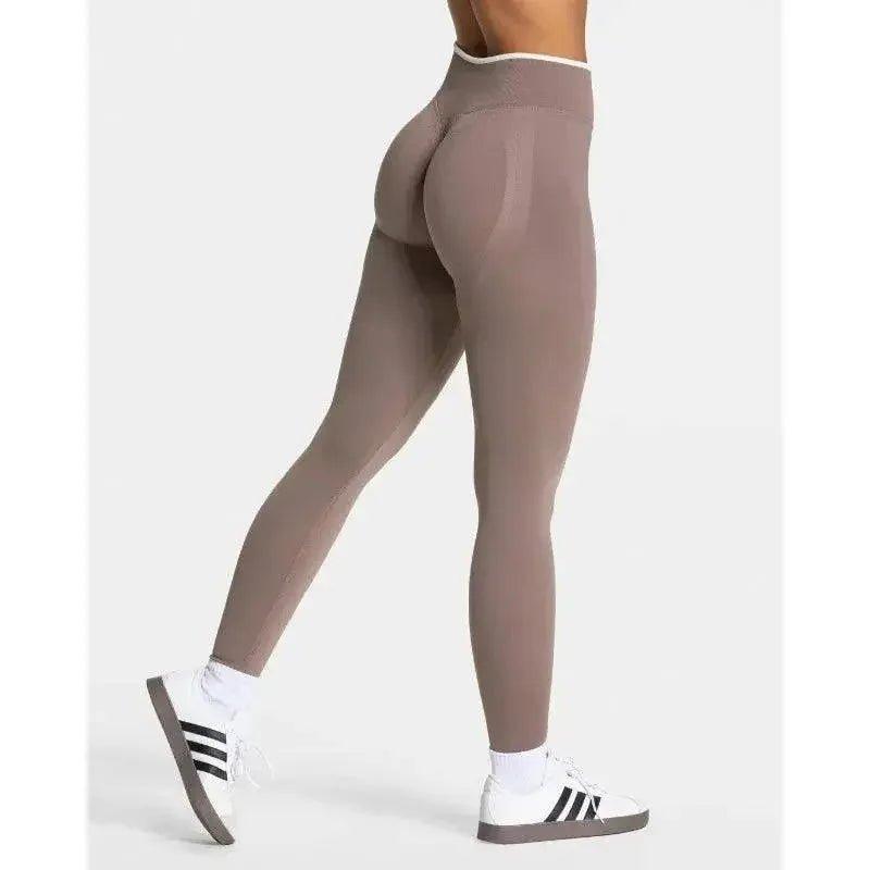 Women's high-waisted seamless leggings with tummy control, paired with white sneakers for gym or casual wear