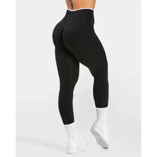 Black high-waisted leggings with white waistband, styled with white socks and sneakers for women's fashion