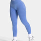 Women's high-waisted blue leggings with white sneakers, fitness fashion