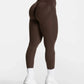 Brown high-waisted leggings with white trim, paired with white sneakers and socks, ideal for women's fashion and fitness.