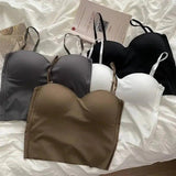 Women's fashion bras in black, white, gray, and olive on a soft bedspread
