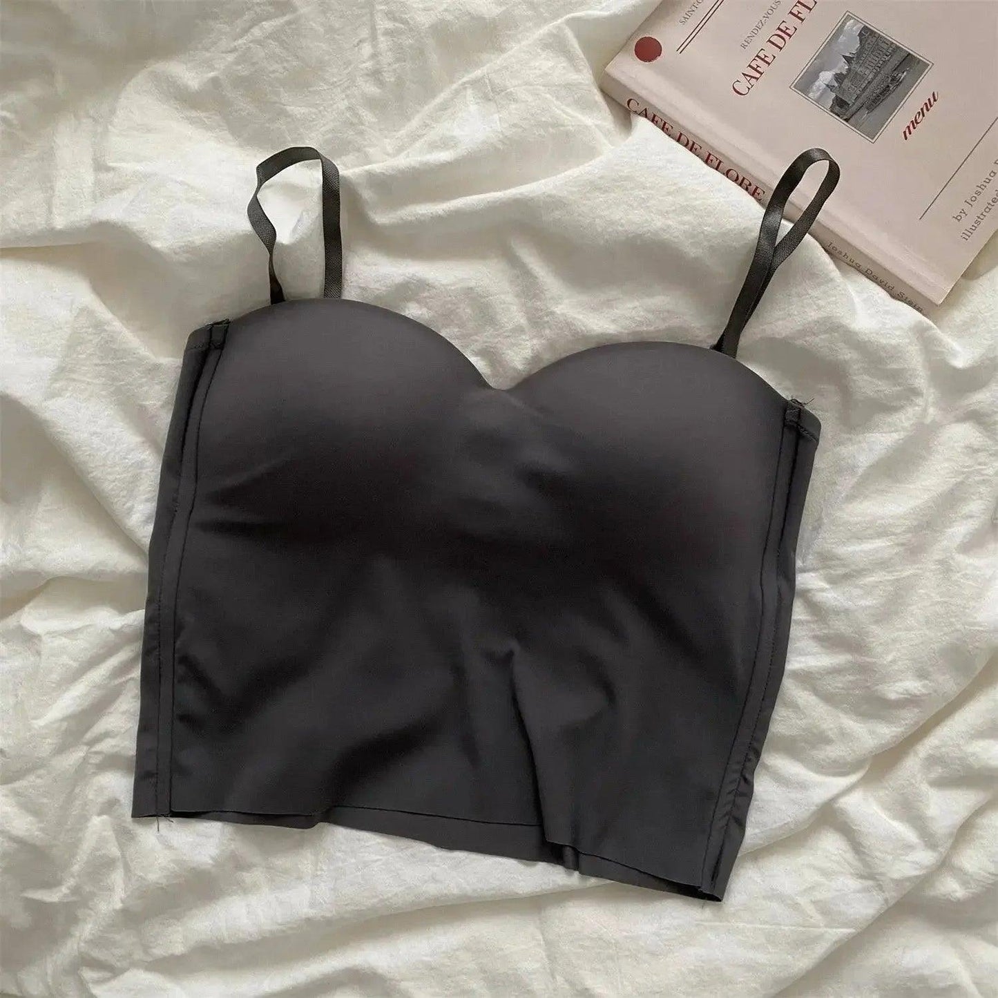 Black strapless bralette on white linen with cafe menu book, women's fashion lingerie
