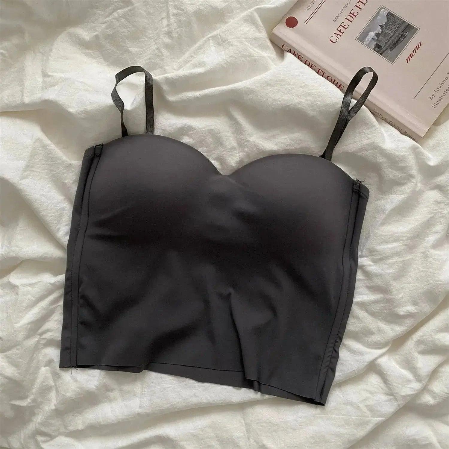 Black strapless bralette on white linen with cafe menu book, women's fashion lingerie