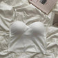 White strapless bralette on soft bedding, minimalist women's fashion