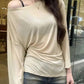 Beige off-shoulder long sleeve top with ruched detail, paired with denim shorts for casual women's fashion