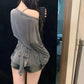 Woman taking mirror selfie in gray off-shoulder top and denim shorts, casual fashion outfit