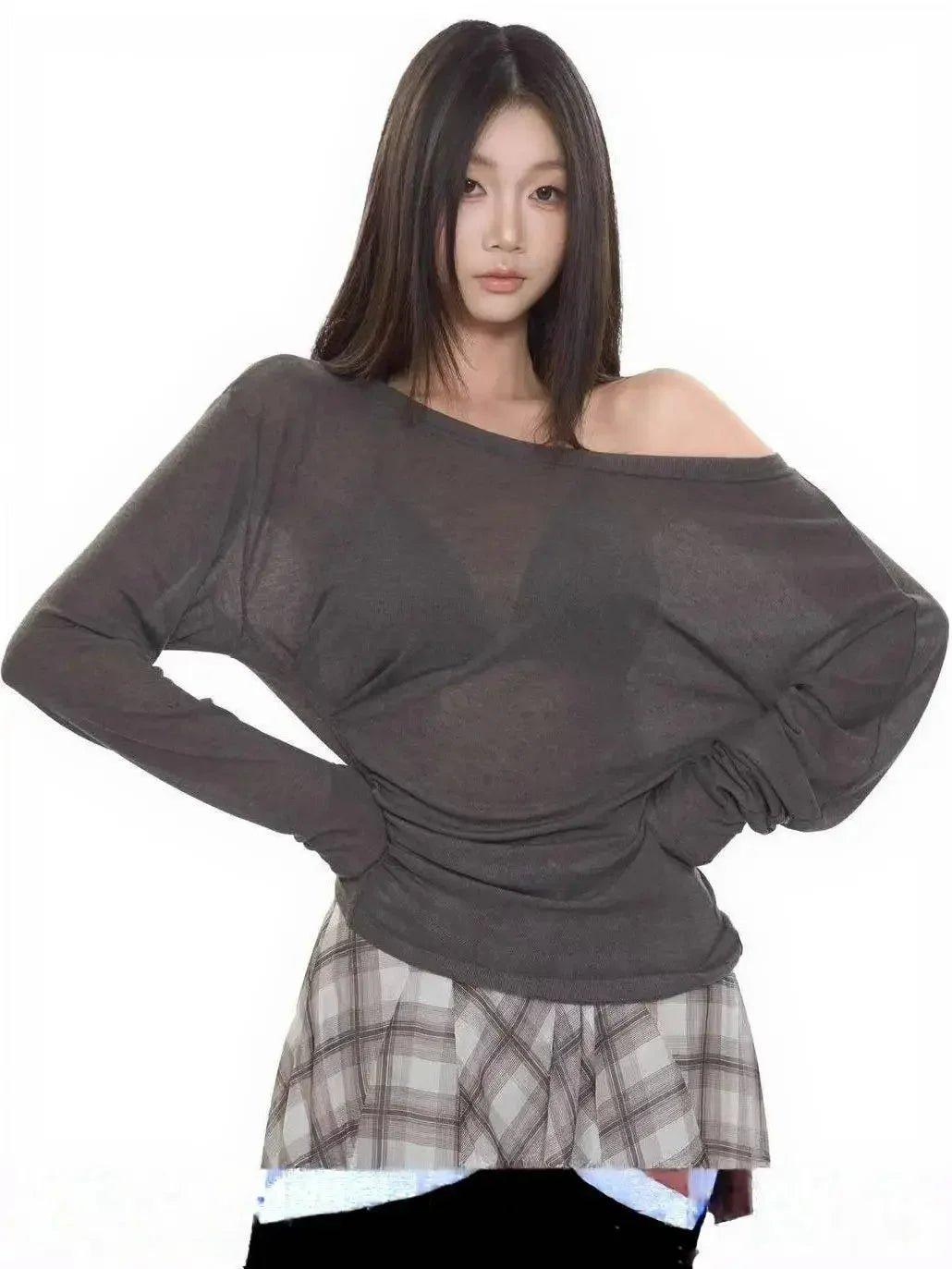 Woman wearing off-shoulder long sleeve top with plaid skirt, stylish fashion outfit