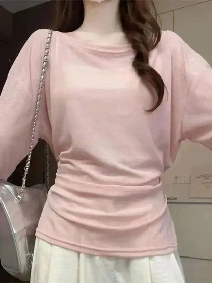 Pink long sleeve women's fashion top with ruched hem and chain strap bag