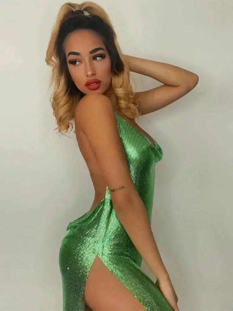 Woman in shimmering green sequin dress with high slit, elegant evening fashion