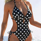 Black and white polka dot one-piece swimsuit with side cutouts and halter neck, beach fashion