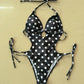 Black and white polka dot one-piece swimsuit with halter neck and side ties, women's fashion swimwear