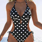Black and white polka dot one-piece swimsuit with side cutouts and halter neck, beach fashion