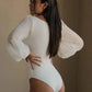 Woman in white bodysuit with sheer puff sleeves, back view, fashion apparel