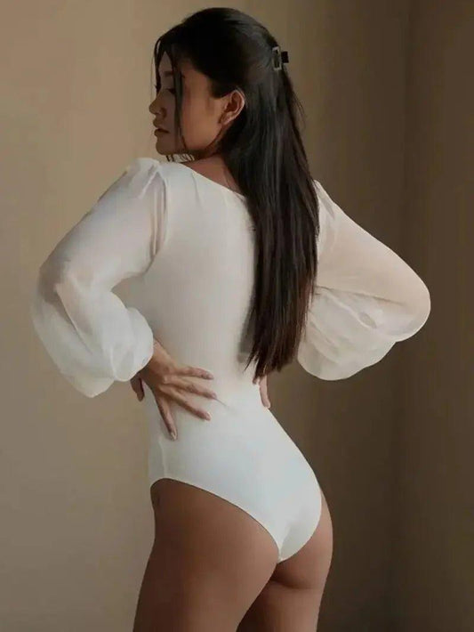 Woman in white bodysuit with sheer puff sleeves, back view, fashion apparel