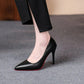 Black pointed-toe high heels with red sole, worn with black pants, women's fashion footwear