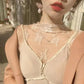 Elegant lace top with floral embroidery, sheer neckline, and pearl earrings for women's fashion