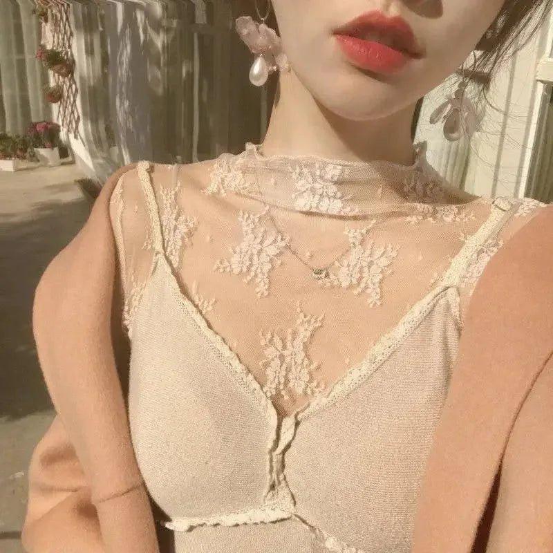 Elegant lace top with floral embroidery, sheer neckline, and pearl earrings for women's fashion