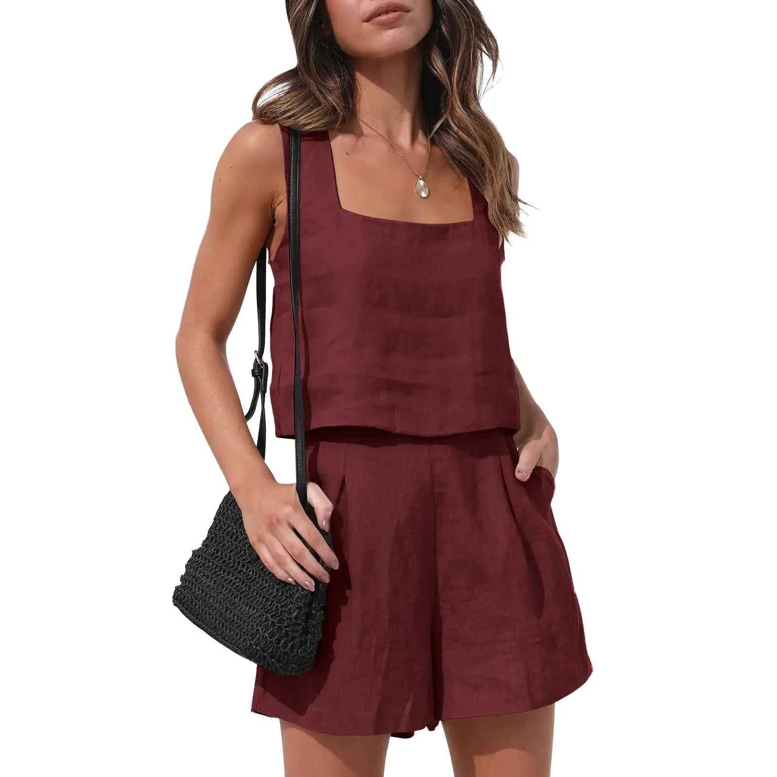Burgundy linen two-piece set with square neck top and pleated shorts, styled with black woven bag