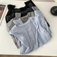 Women's basic long sleeve tops in black, gray, and light blue, folded on white table for fashion styling