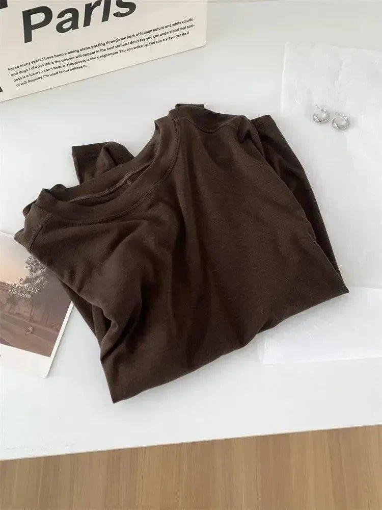 Brown women's fashion top with Paris magazine and earrings, stylish casual wear