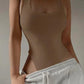 Beige ribbed tank top with square neckline, paired with gray sweatpants for casual women's fashion
