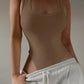 Beige ribbed tank top with wide straps, styled with gray sweatpants for casual women's fashion