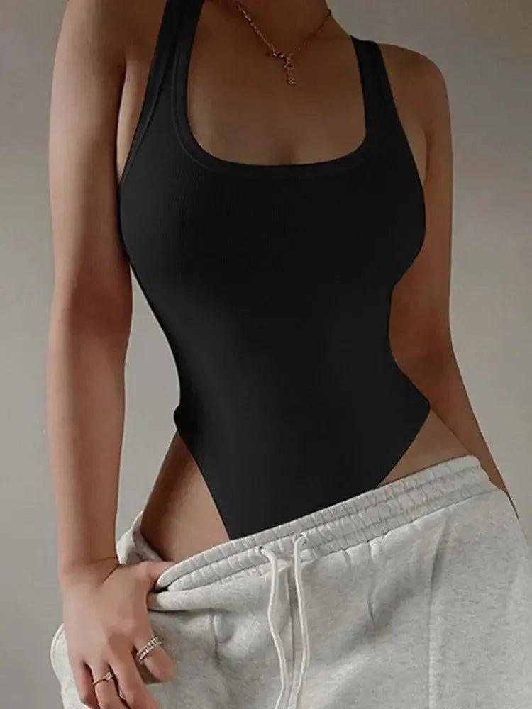 Black ribbed bodysuit with side cutouts, paired with gray sweatpants for casual women's fashion