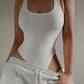 White ribbed bodysuit with side cutouts paired with gray sweatpants, women's fashion