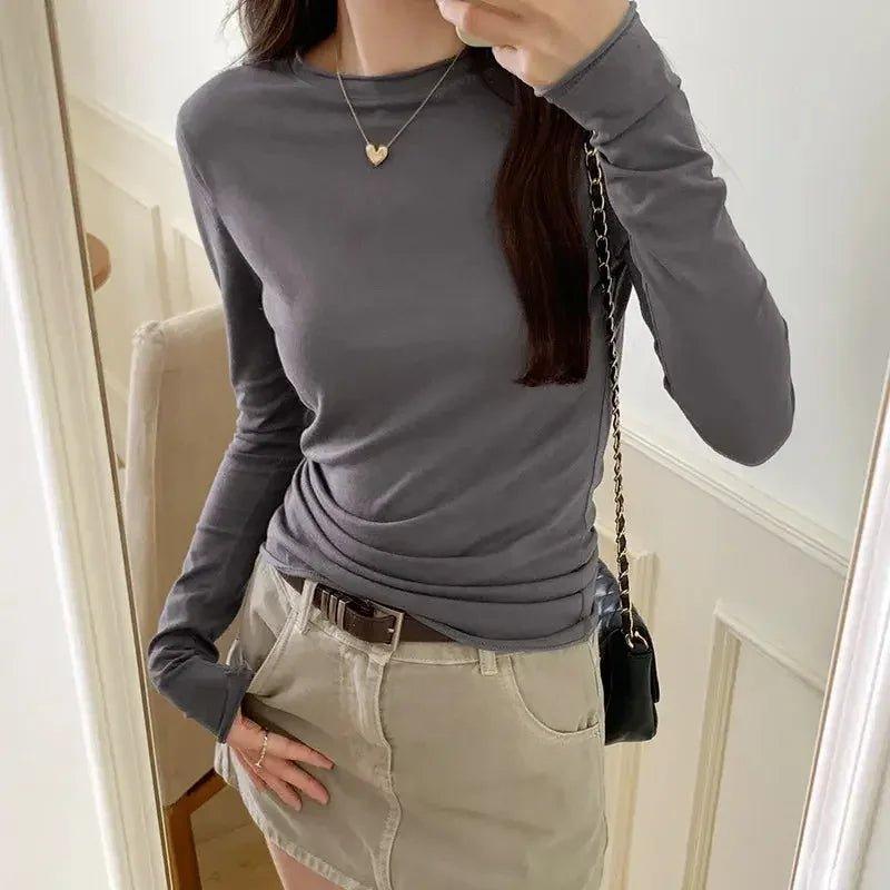 Woman in gray long sleeve top and beige skirt, stylish casual fashion outfit