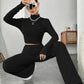 Woman in black ribbed knit crop top and wide-leg pants, stylish fashion outfit