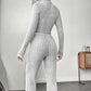 Woman in gray ribbed knit jumpsuit with long sleeves and flared legs, fashion outfit