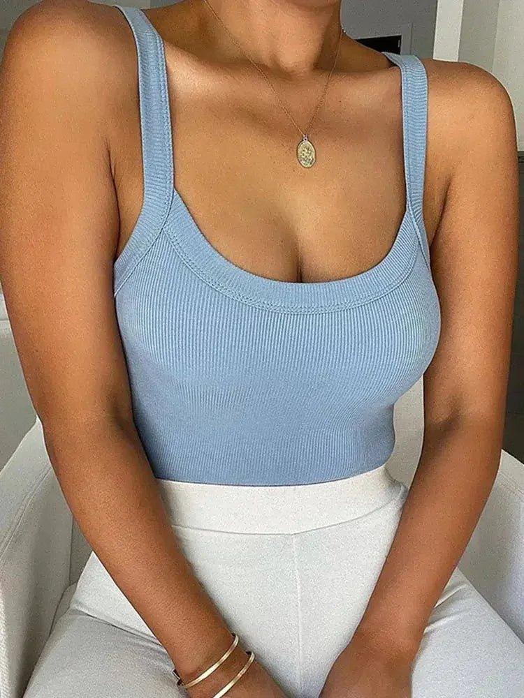 Light blue ribbed crop top with wide straps, paired with white pants, perfect for women's fashion