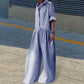 Woman wearing blue and white gingham jumpsuit with wide legs, casual street style fashion