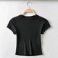 Black women's short sleeve crop top on wooden hanger, minimalist fashion