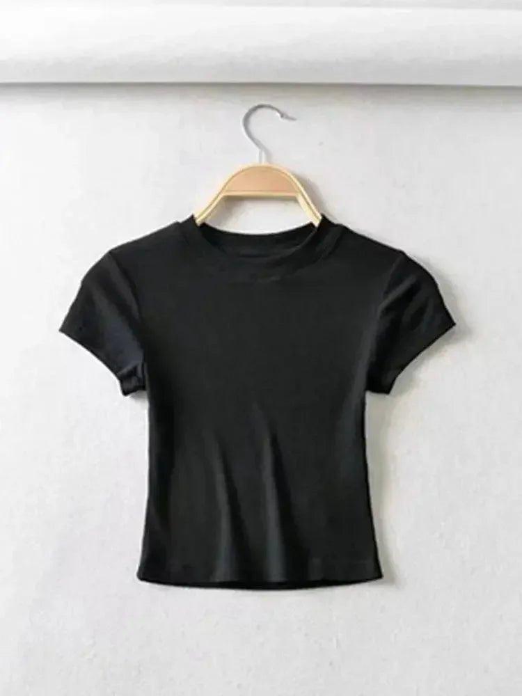Black women's short sleeve crop top on wooden hanger, minimalist fashion style
