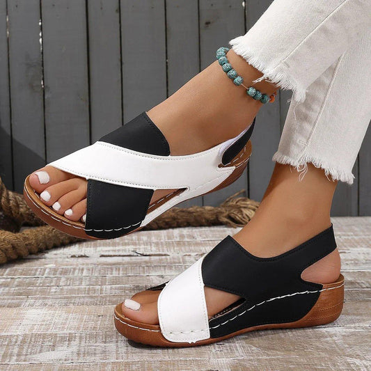 Women's black and white wedge sandals with crisscross straps, perfect for summer fashion