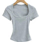 Gray ribbed women's crop top with square neckline and short sleeves on wooden hanger