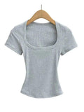 Gray ribbed women's crop top with square neckline and short sleeves on wooden hanger