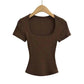Brown ribbed women's crop top with square neckline, short sleeves, on wooden hanger