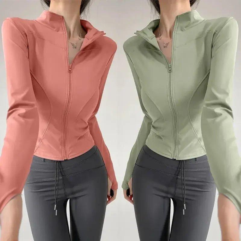 Women's zip-up athletic jackets in pink and green, paired with gray leggings for fitness fashion