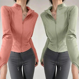 Women's zip-up athletic jackets in pink and green, paired with gray leggings for fitness fashion